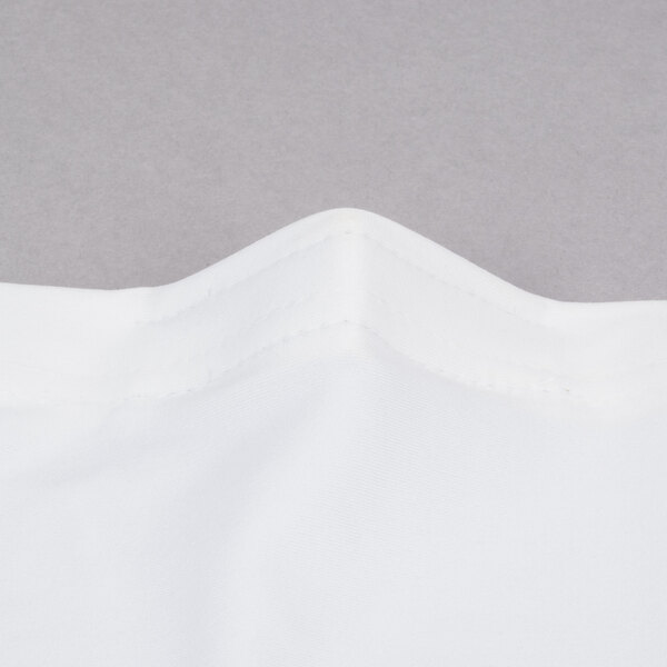 A close up of a white fabric with a folded edge.