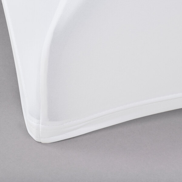 A white Snap Drape Contour Table Cover on a table.