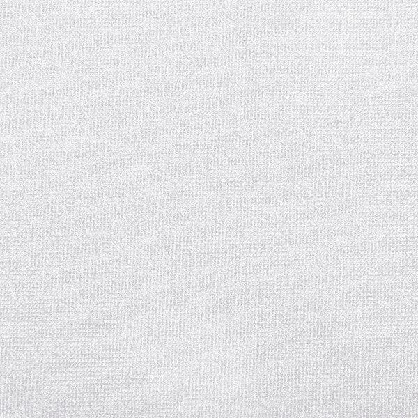 A close-up of a white spandex table cover with a small hole.