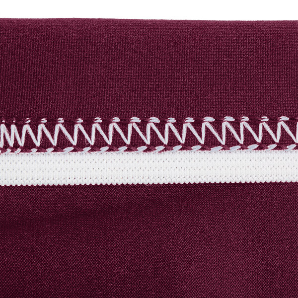 A burgundy spandex table cover with a close-up of the fabric.