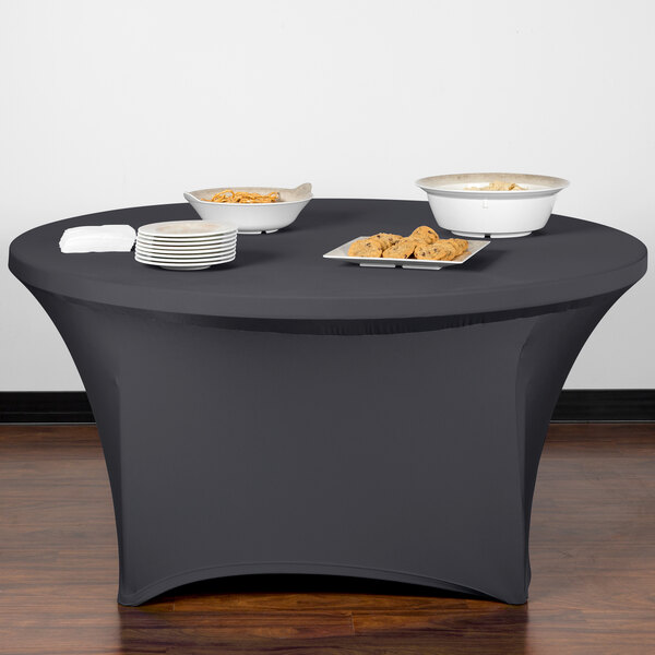 A charcoal Snap Drape spandex table cover on a table with plates of food.