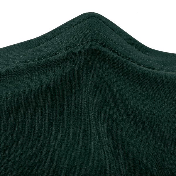 A close-up of a hunter green Snap Drape Contour spandex table cover.