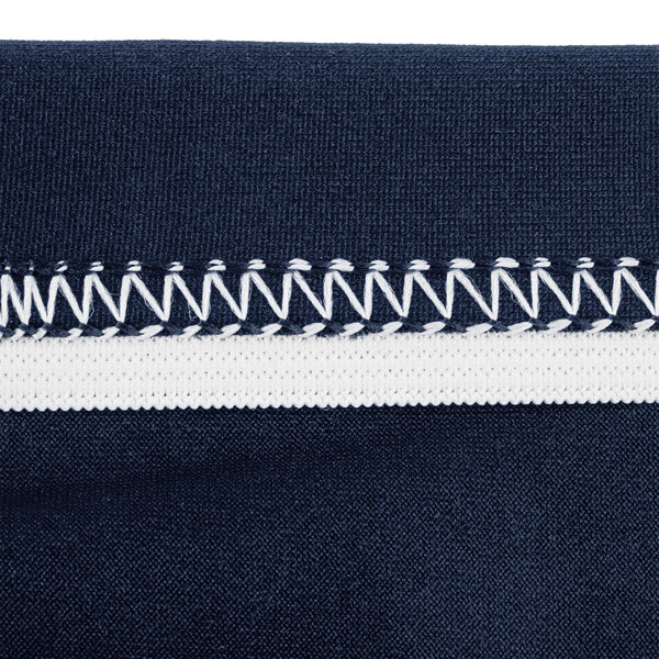 A close up of a navy blue spandex fabric zipper with white stitching.