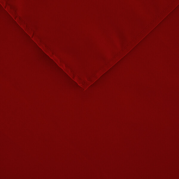 A red rectangular polyester table cover with a folded edge.