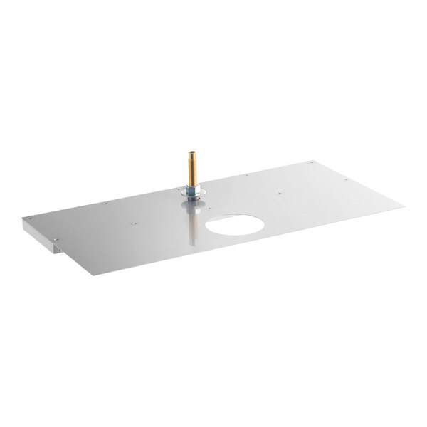 A rectangular stainless steel plate with a central circular hole, a raised brass fitting, and several screws, likely designed for mounting and drainage purposes.
