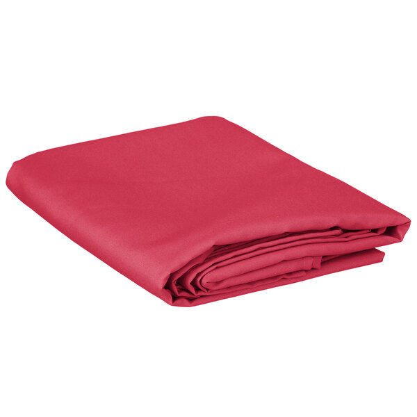A folded hot pink rectangular table cover.