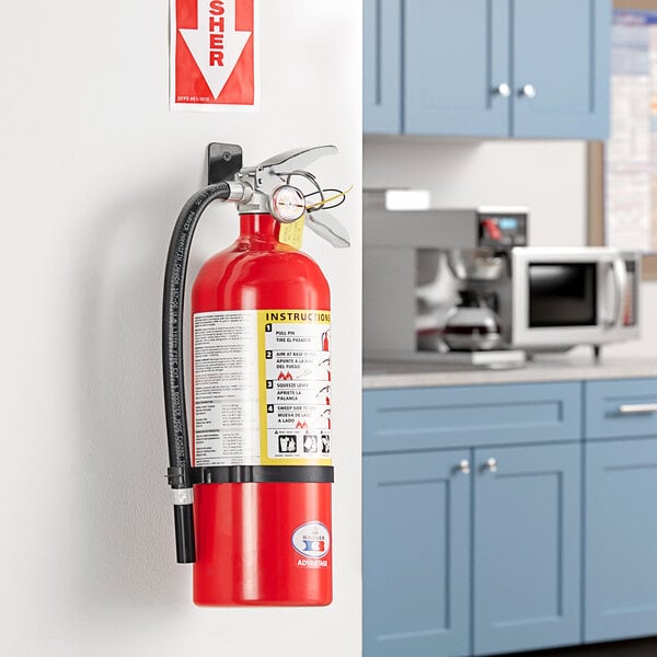 A Badger Advantage ABC fire extinguisher attached to a wall.