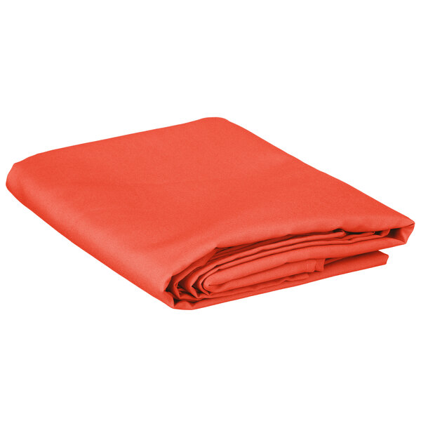 A folded orange rectangular Intedge table cover.