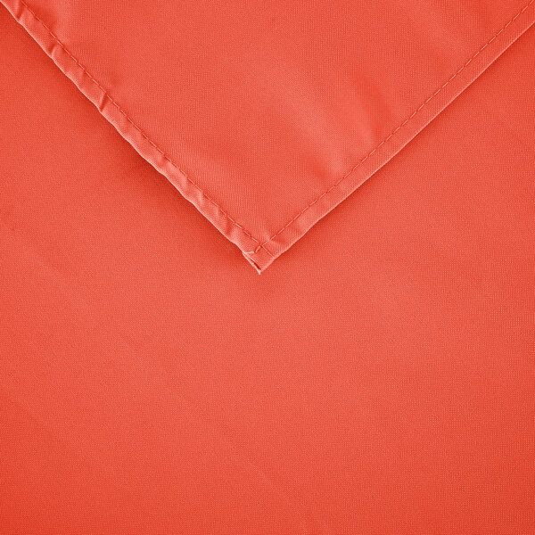 A close-up of an orange Intedge cloth table cover.