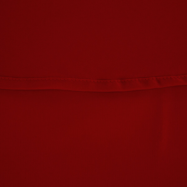 A close up of a red fabric table cover.