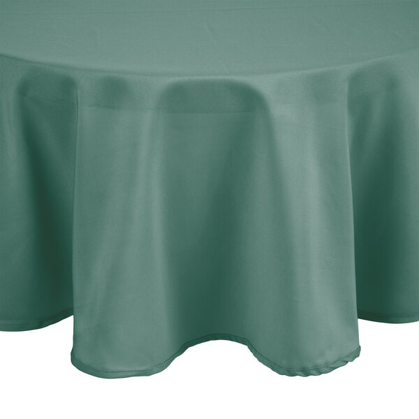 A round seafoam green Intedge tablecloth on a round table.
