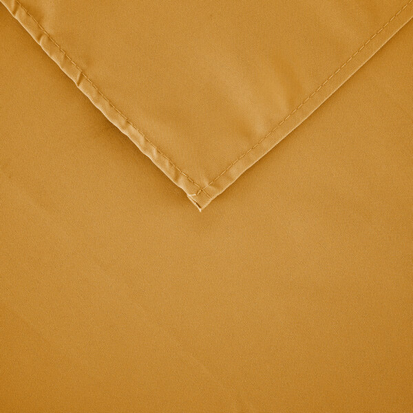 A close-up of a gold rectangular polyester table cover.