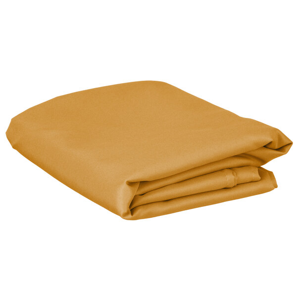 A stack of folded gold rectangular Intedge table covers.