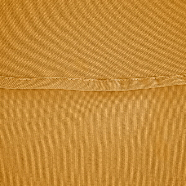 A close up of a gold fabric with a small hole.