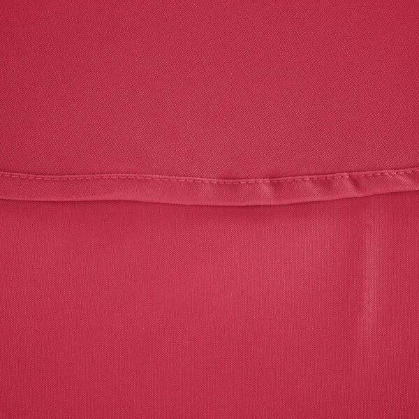 A close-up of a hot pink hemmed table cover.