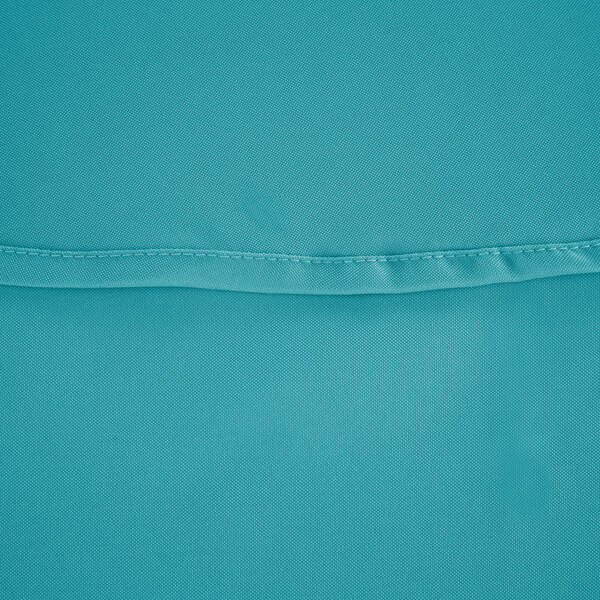 A close up of a teal blue fabric with a stitch.