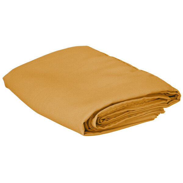 A folded gold square table cover.
