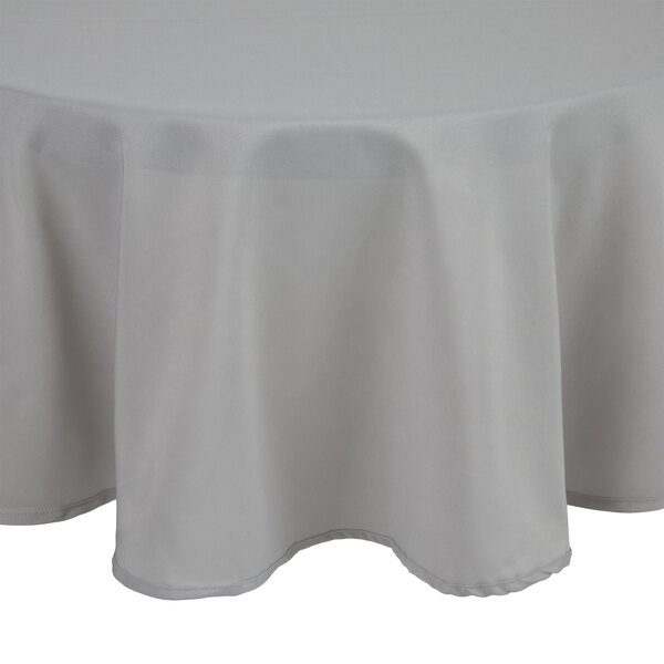 An Intedge gray polyester tablecloth on a round table.