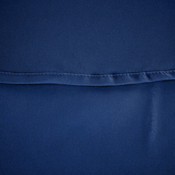 A close up of a royal blue polyester table cover with a small hole in it.