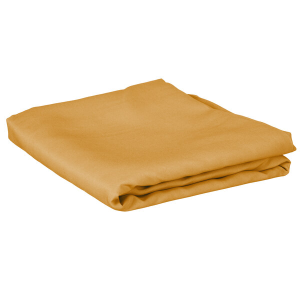 A folded gold table cover on a white background.