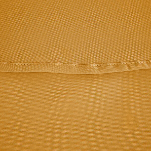 A close up of a gold polyester fabric with a small hole.