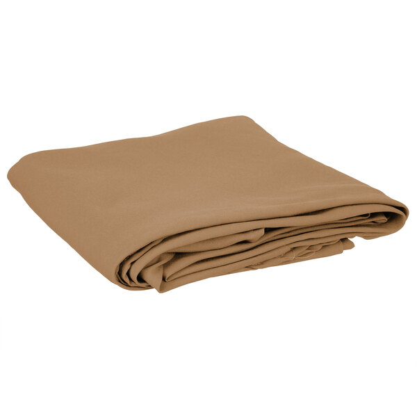 A folded beige Intedge round table cover.