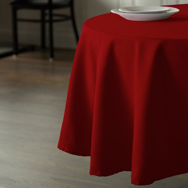 a round red tablecloth on a table