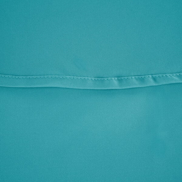 A close up of a teal blue fabric with a stitch along the edge.