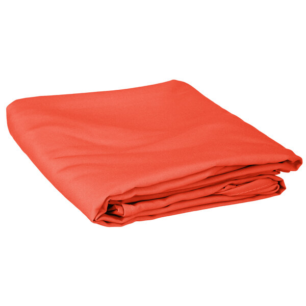 An orange Intedge round table cover folded on a white background.