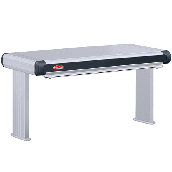 A grey rectangular Hatco Glo-Ray strip warmer with black trim on a white and black table.