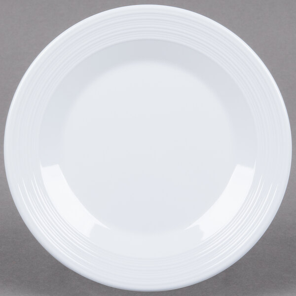 A white Minski melamine plate with a textured circular edge.