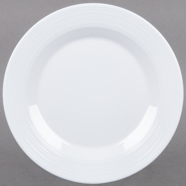 A white Minski melamine plate with a textured rim.