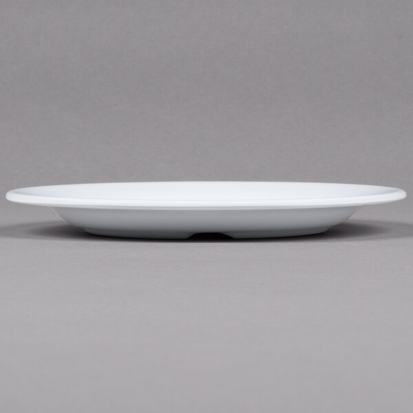 A close up of a GET Centuria white melamine plate with a rim.