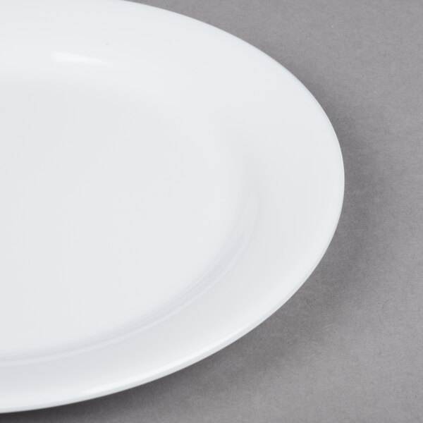 A close up of a GET Centuria white melamine plate with a white rim.