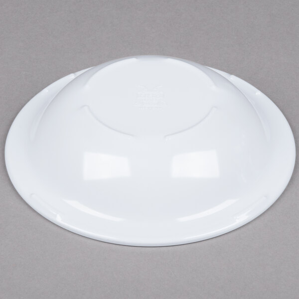 A white melamine bowl on a gray surface.