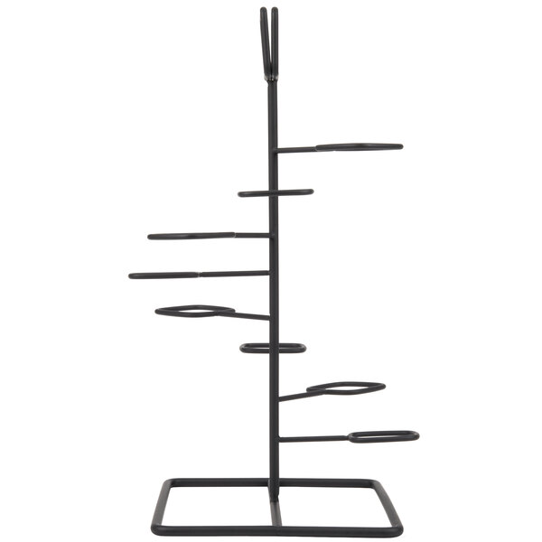 A black metal tower display stand with six round objects on it.