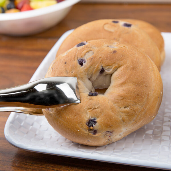 A white Coralline melamine display tray with two bagels on it.
