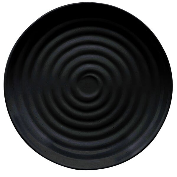 A black melamine round plate with a spiral pattern in the middle.