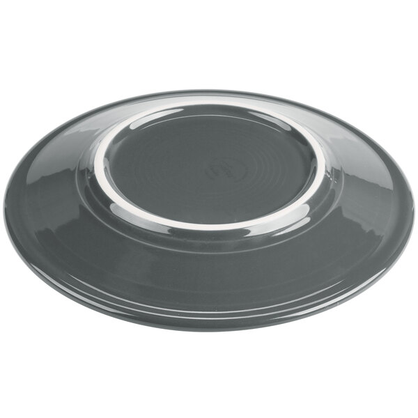 A close-up of a grey Fiesta luncheon plate with a white rim.