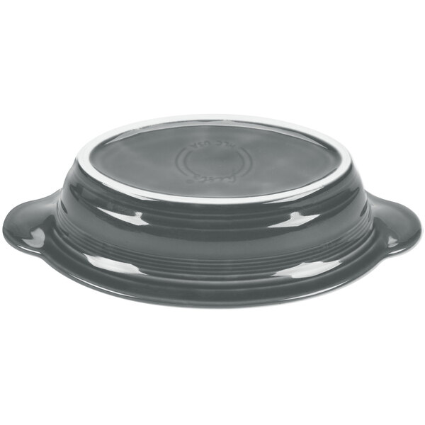 A black slate oval casserole dish with a silver rim.