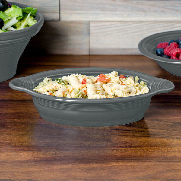 A Slate Fiesta oval china baker filled with pasta and salad.