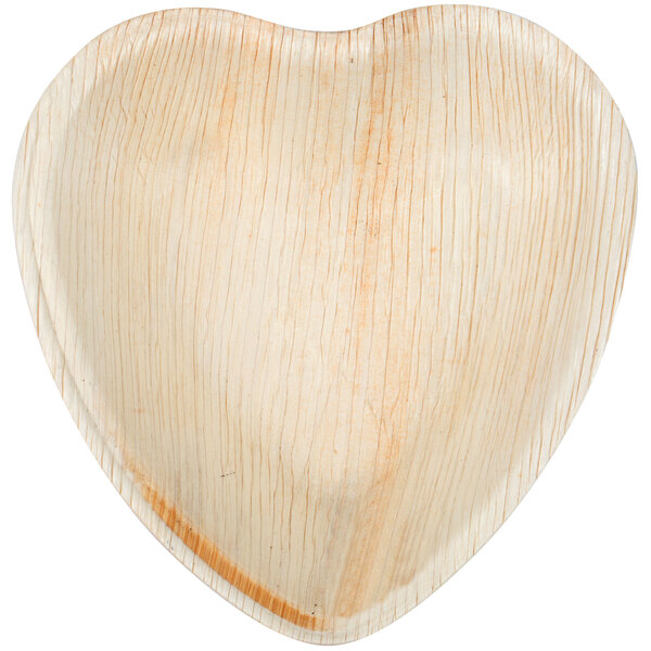 An Eco-gecko palm leaf heart shaped plate with a white surface.