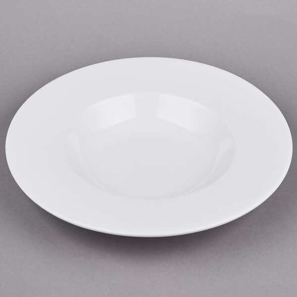 An Arcoroc white porcelain pasta bowl with a rim.