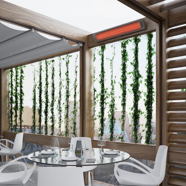 A wall-mounted electric outdoor patio heater installed in a modern covered patio area.