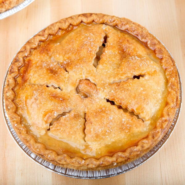 Two D&W Fine Pack aluminum foil pies in medium depth pie pans on a table.