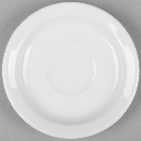 A Tuxton bright white narrow rim china demitasse saucer on a white surface.