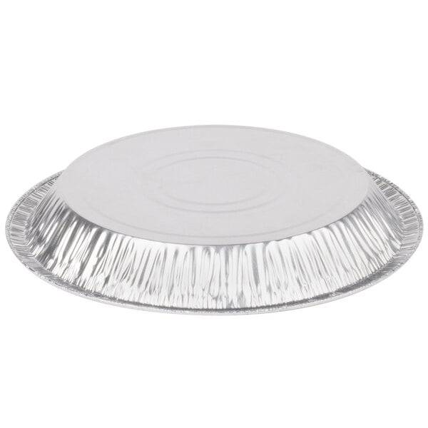 A close-up of a round silver aluminum foil pie pan with a round edge.