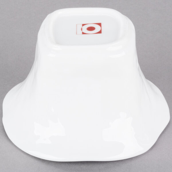 A white bowl with a square base with white pearls on it.