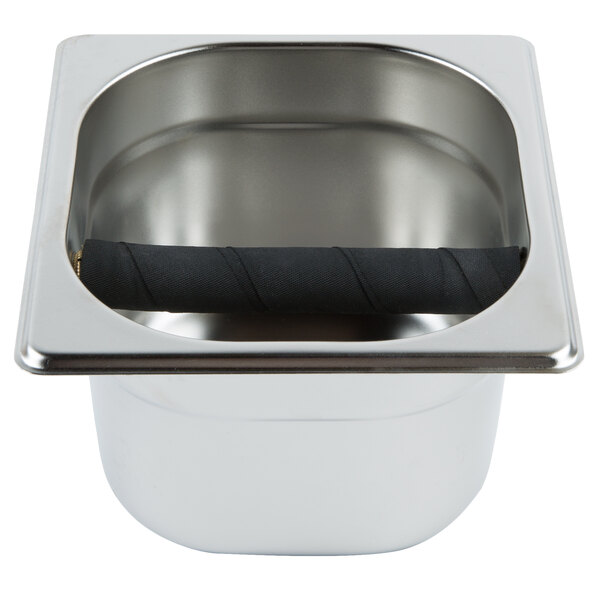 A stainless steel knock box with a black handle on a counter.