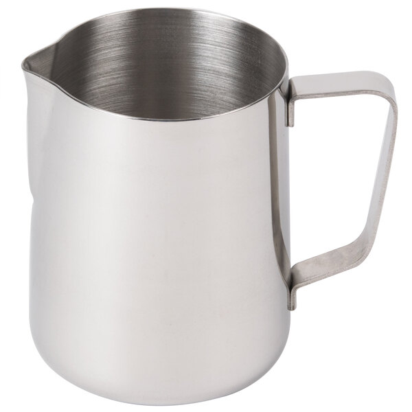 A silver stainless steel milk pitcher with a handle.
